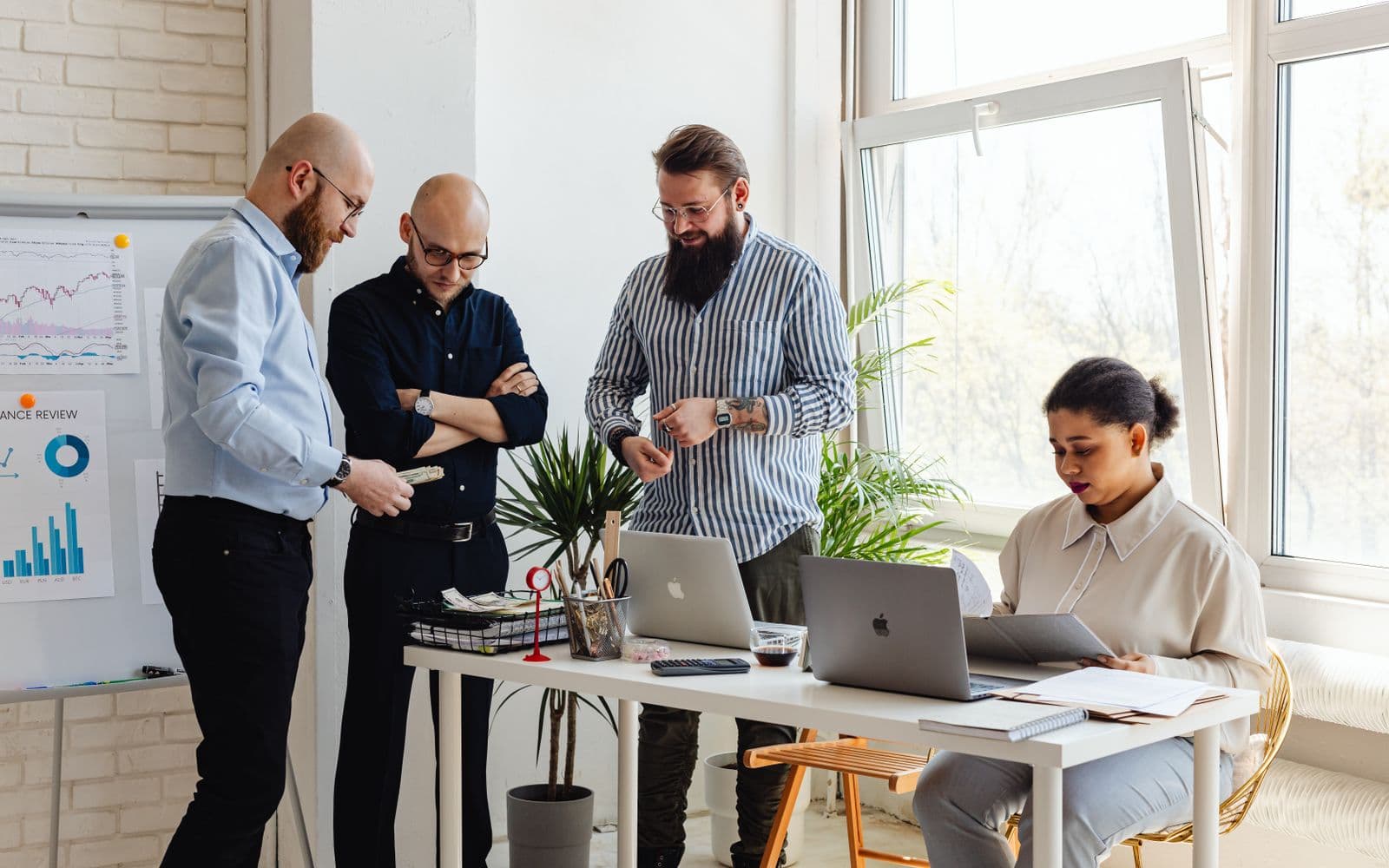 A mixed team reviewing charts in a bright open-plan office